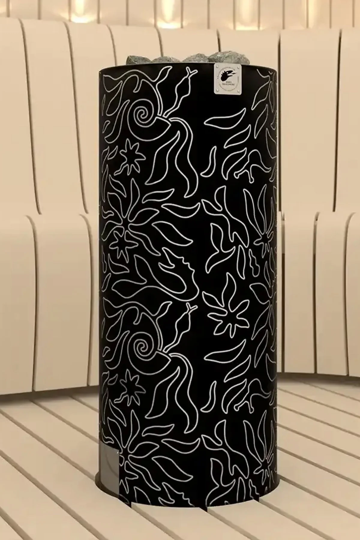 Black SAWO Dragonfire tower heater with a white Junglefire line pattern, in a curved-slat sauna
