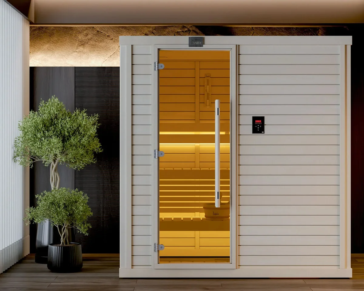 White-clad SAWO sauna cabin with a golden-tinted glass door and an olive tree beside it