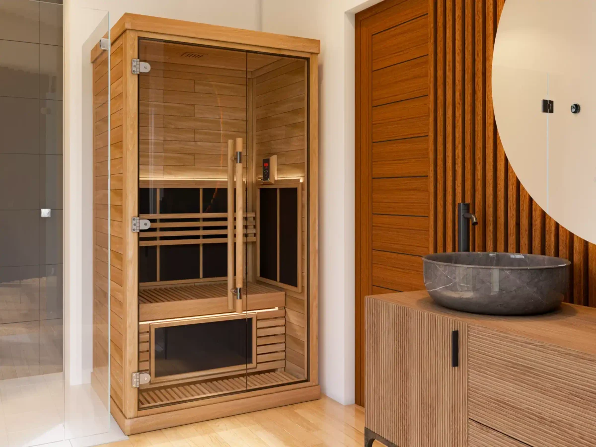 SAWO 2-person infrared sauna room installed beside a marble bathroom vanity, panels glowing warmly